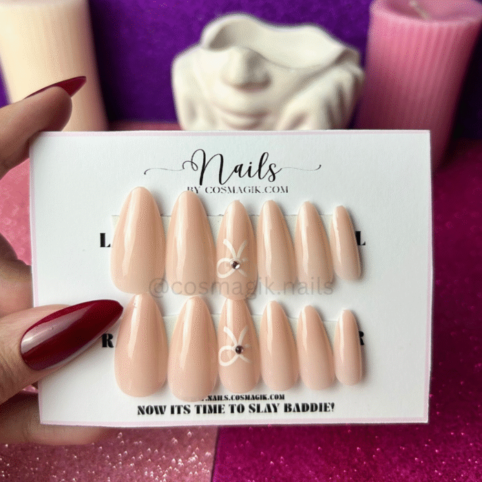 Soft whisper nude pink press-on nails with bow design by Nails by Cosmagik – reusable elegant nails in Pakistan